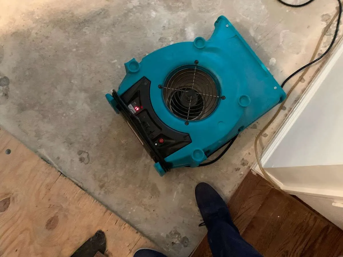 Air mover drying subfloor during Commercial Water Damage Restoration in El Centro